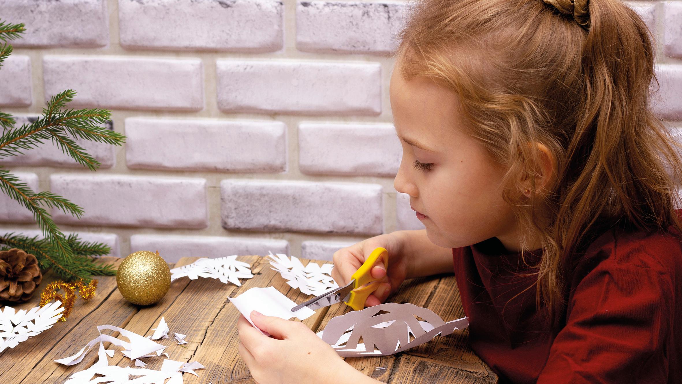 Kleines Mädchen bastelt etwas zu Weihnachten